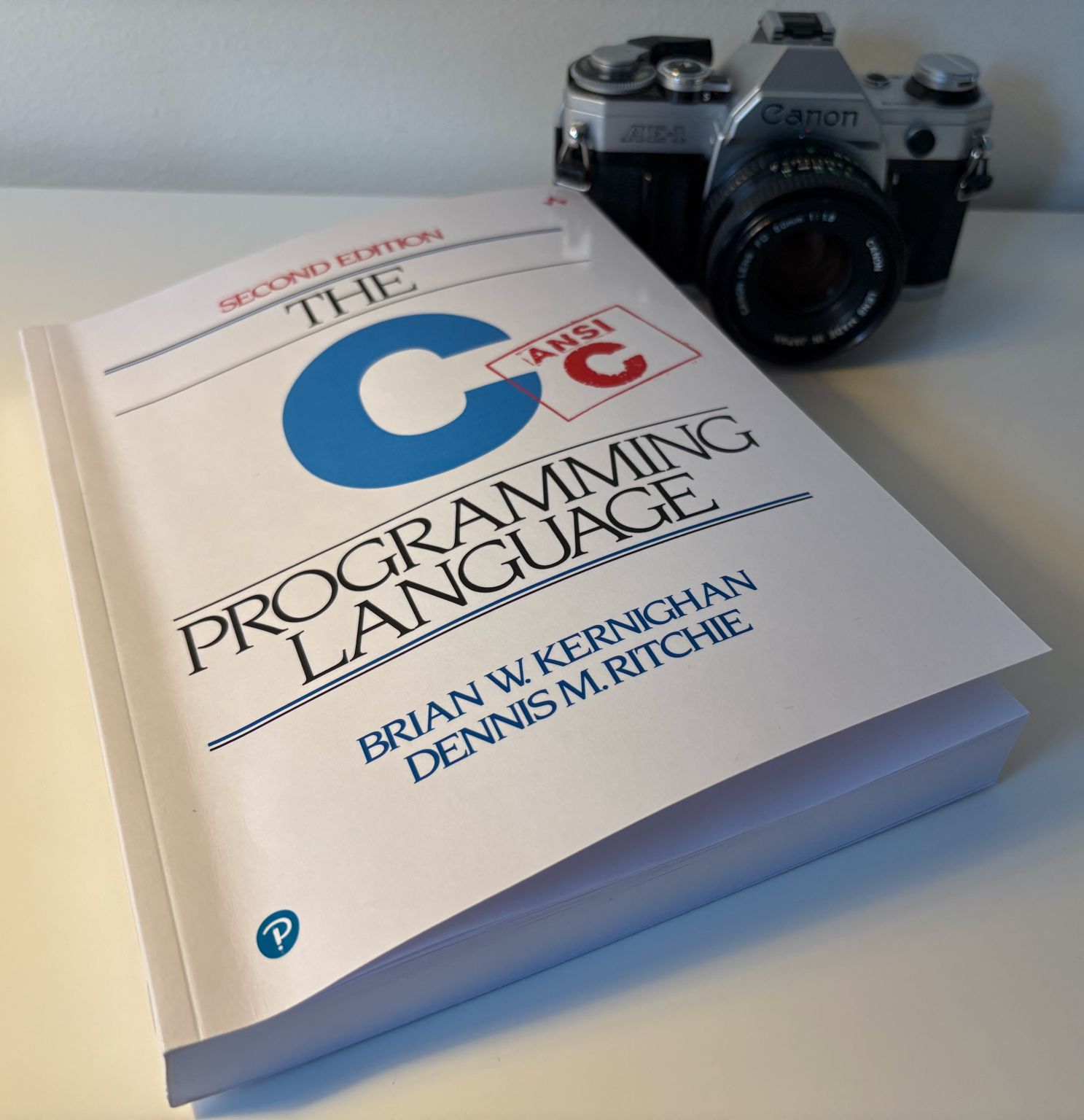 The C Programming Language book and camera